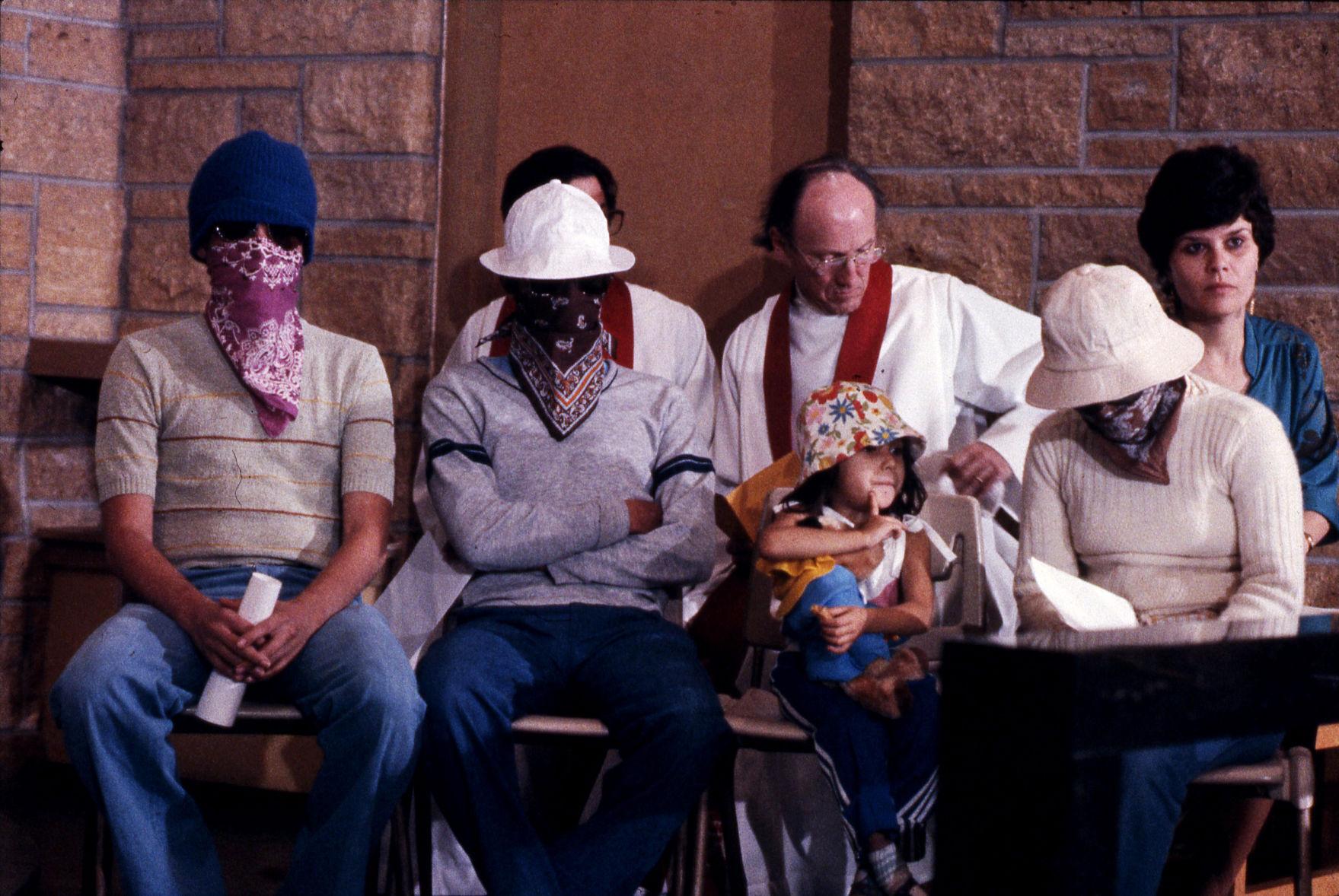 Photo of Rev. Arthur Lloyd and Laurie Lemel sitting behind four El Salvador refugees at St. Francis House, circa 1983 Photo of Rev. Arthur Lloyd and Laurie Lemel sitting behind four El Salvador refugees at St. Francis House, circa 1983