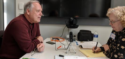 Greg Mickells with interviewer, Municipal Restored, 2018