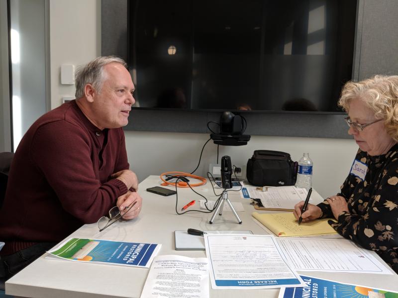 Photograph of Greg Mickells with interviewer, Municipal Restored, 2018