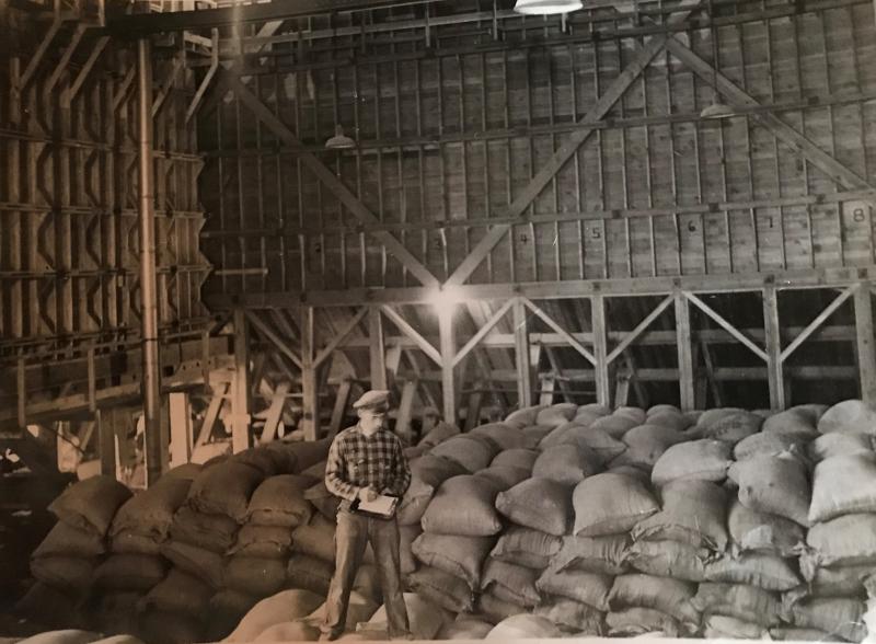 Mill foreman standing on feed bags