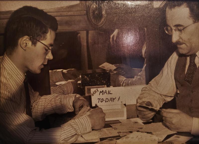 Sam Schwartz (right) and Alex Swartz (left) sort through mail sent to the pharmacy by soldiers serving during WWII, Madison, ca. 1943.